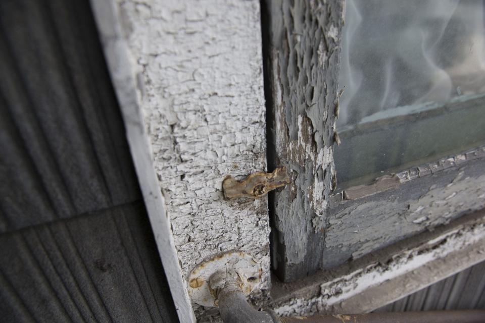 A window with lead paint chipping off.