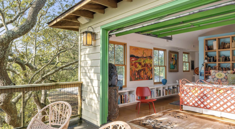 A garage door leads to a private patio from the primary bedroom, which also has an en suite bath.