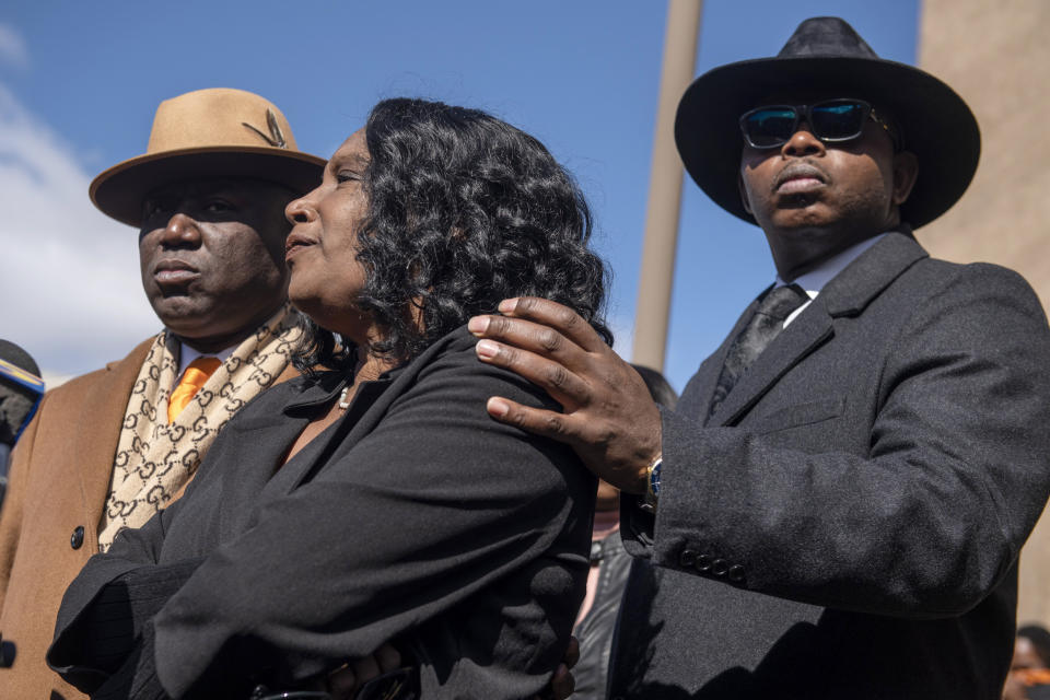 RowVaughn Wells, center, the mother of Tyre Nichols, stands with attorneys Ben Crump, left, and Kareem Ali as she speaks during a press conference after an indictment hearing for five former Memphis police officers charged in the death of her son at the Shelby County Criminal Justice Center Friday, Feb. 17, 2023, in Memphis, Tenn. (AP Photo/Brandon Dill)