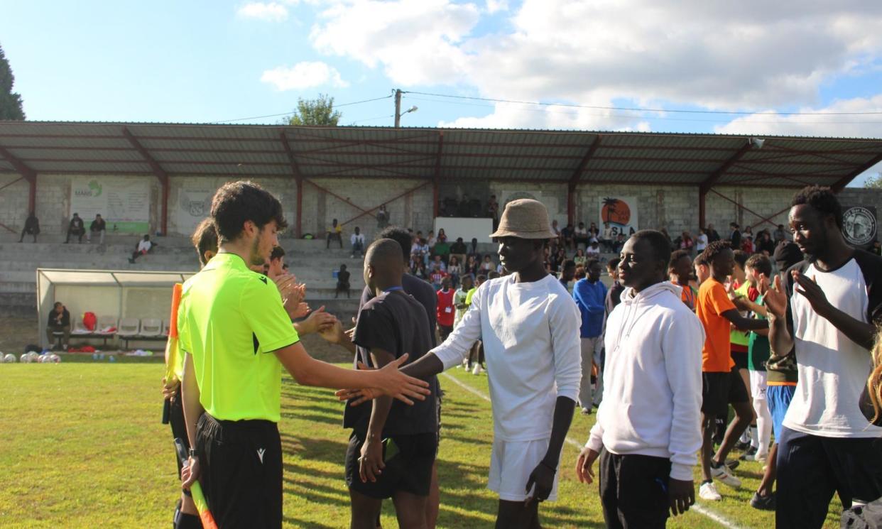 <span>Refugees meet players and officials before a Sociedad Deportiva Monterroso game.</span><span>Photograph: Courtesy S D Monterroso/Handout</span>