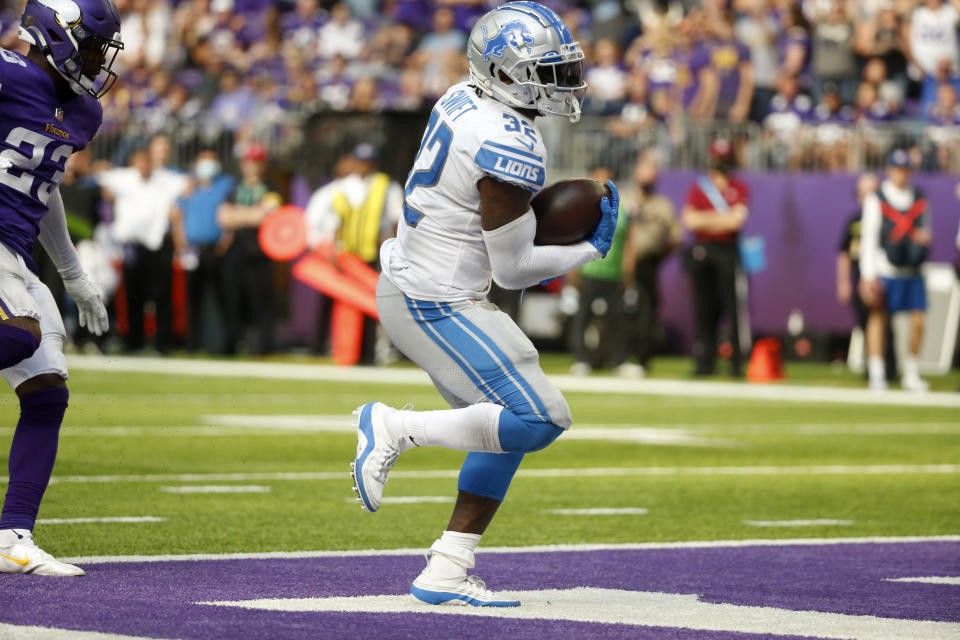 Detroit Lions running back D'Andre Swift (32) scores on a 7-yard touchdown run during the second half of an NFL football game against the Minnesota Vikings, Sunday, Oct. 10, 2021, in Minneapolis. (AP Photo/Bruce Kluckhohn)