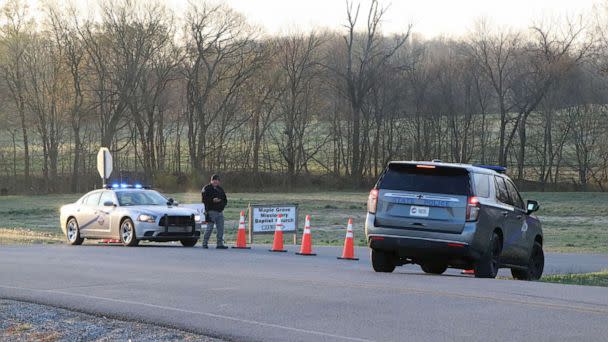 PHOTO: A security official stands near police cars at a site where two U.S. Army Black Hawk helicopters crashed in Trigg County, Kentucky, March 30, 2023. (Wkdz Radio/Reuters)