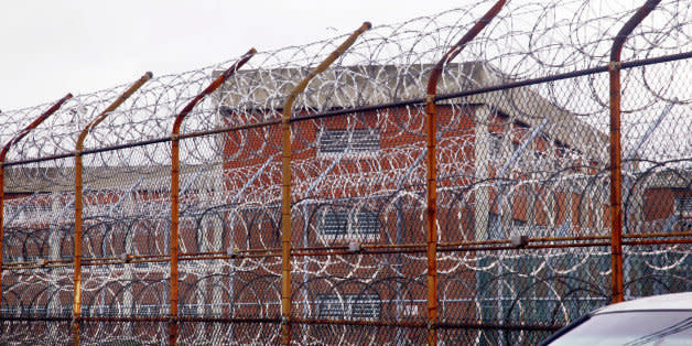 FILE - In this March 16, 2011, file photo, a security fence surrounds the inmate housing on New York's Rikers Island correctional facility in New York. A wide-ranging independent review, obtained by The Associated Press, is critical of the city's use of solitary confinement at Rikers Island, as punishment for inmates who by the very nature of their mental illnesses are more prone to breaking jailhouse rules. The report recommends eliminating the use of solitary for mentally ill inmates as a punishment and instead partnering with a teaching hospital to provide intensive therapeutic services. The study was commissioned by the New York City Board of Correction, which has a watchdog role over the city's Department of Correction. (AP Photo/Bebeto Matthews, File) (Photo: )