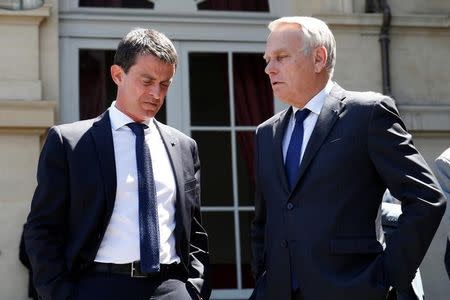 French Prime Minister Manuel Valls (L) and Foreign Minister Jean-Marc Ayrault talk before a visit to the Interministerial Victim Support Unit (CIAV) at the Foreign Ministry in Paris, France, July 16, 2016. REUTERS/Matthieu Alexandre/Pool