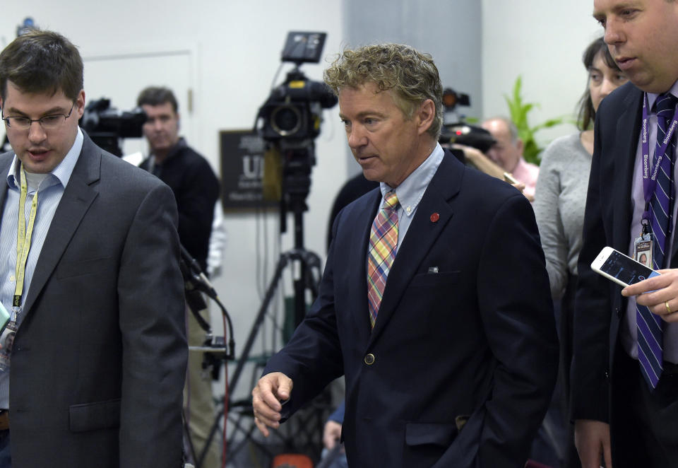 Sen. Rand Paul, R-Ky., center, speaks to reporters following a briefing on Syria on Capitol Hill in Washington, Friday, April 7, 2017. Amid measured support for the U.S. cruise missile attack on a Syrian air base, some vocal Republicans and Democrats are reprimanding the White House for launching the strike without first getting congressional approval. (AP Photo/Susan Walsh)