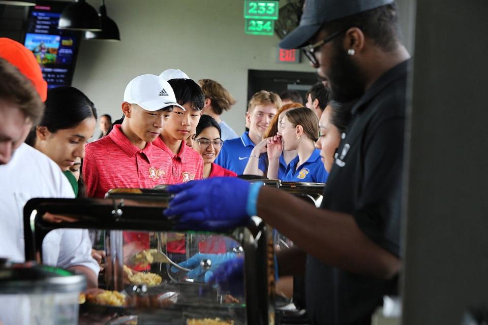 GMC golfers enjoy the hot lunch buffet during Sunday's Tee Off Against Hunger at TopGolf in Edison to benefit Hands of Hope for the Community.