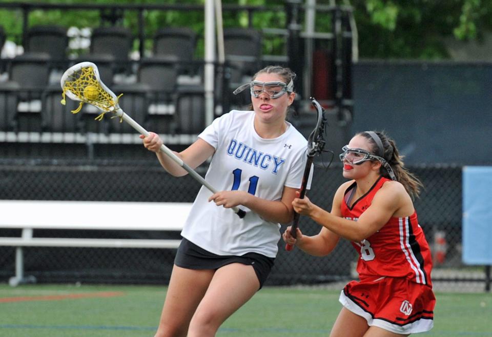 Quincy's Delia Nichol, left, keeps the ball away from North Quincy's Brianna Alvarado, right, in pursuit, during girls lacrosse at Veterans Stadium in Quincy, Tuesday, May 16, 2023.
