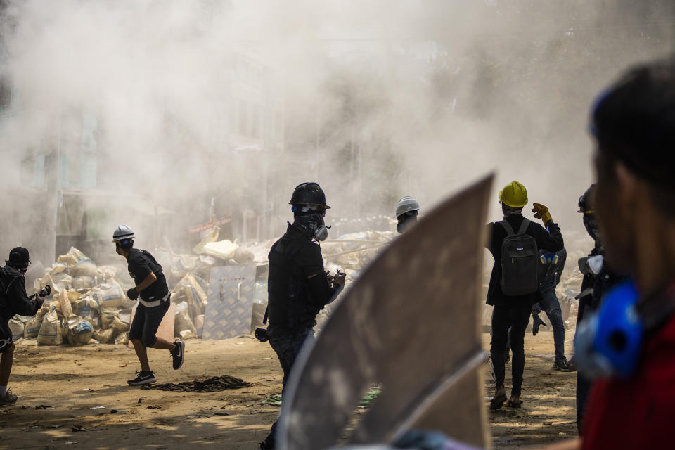 FILE - In this March 14, 2021, file photo, anti-coup protesters scatter during an ongoing police crackdown during a protest in Sanchaung township, Yangon, Myanmar. Protests in Myanmar's largest city turned deadly in March as security forces continued their violent crackdown against dissent following the military coup. Former United Nations Secretary General Ban ki-Moon is urging the world body and Southeast Asian countries to take swift and "strong action" to stop the deadly crackdown in the wake of a military coup in Myanmar. (AP Photo/File)