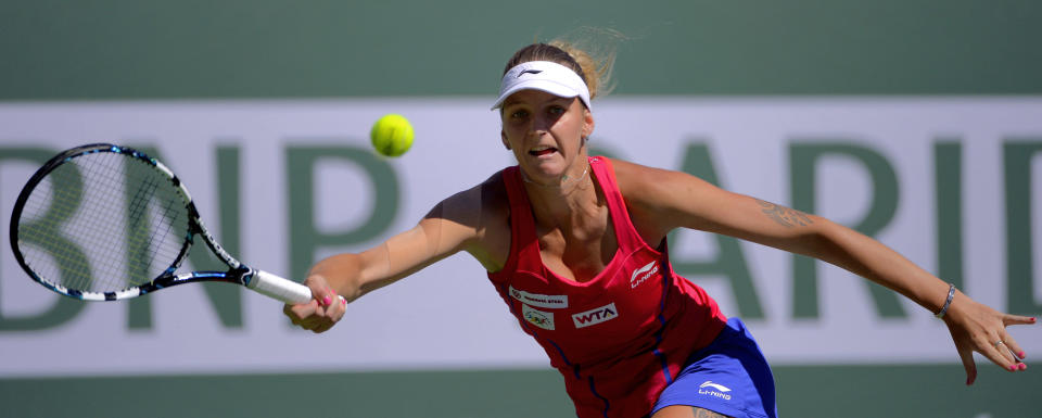 Karolina Pliskova, of the Czech Republic, returns a volley by Li Na, of China, during a third round match at the BNP Paribas Open tennis tournament, Monday, March 10, 2014 in Indian Wells, Calif. (AP Photo/Mark J. Terrill)