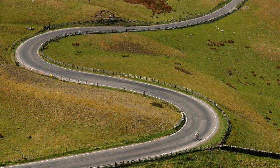 A cyclist is seen on a road in the Peak District National Park, following the outbreak of the coronavirus disease (COVID-19), Mam Tor..