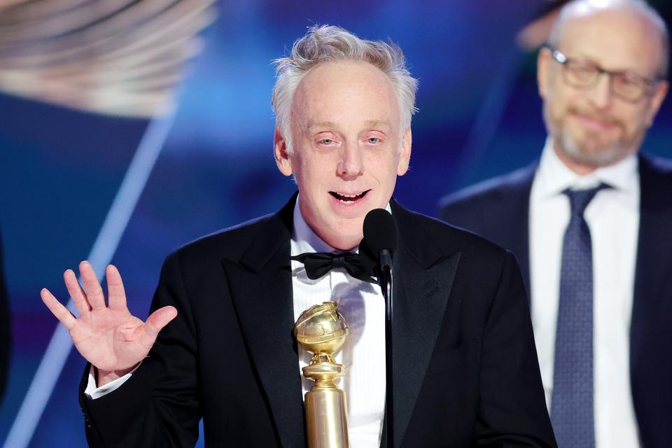 "The White Lotus" creator Mike White (left) accepts the Golden Globe for best limited series.