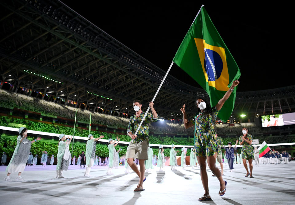 <p>TOKYO, JAPAN - JULY 23: Flag bearers Ketleyn Quadros and Bruno Mossa Rezende of Team Brazil lead their team out during the Opening Ceremony of the Tokyo 2020 Olympic Games at Olympic Stadium on July 23, 2021 in Tokyo, Japan. (Photo by Matthias Hangst/Getty Images)</p> 