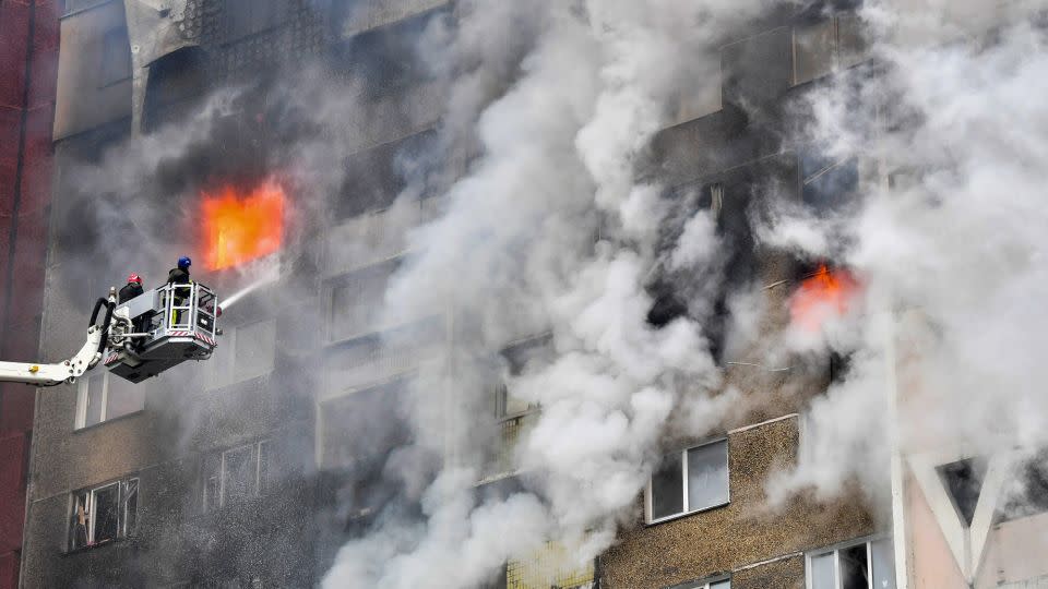 Ukrainian emergency services extinguish a fire in a residential building following a missile attack in the capital Kyiv on February 7. - Sergei Supinsky/AFP/Getty Images