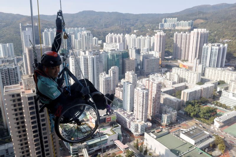 Lai Chi-wai, a paraplegic climber, attempts to climb the 320-metre tall Nina Tower using only his upper body strength in Hong Kong