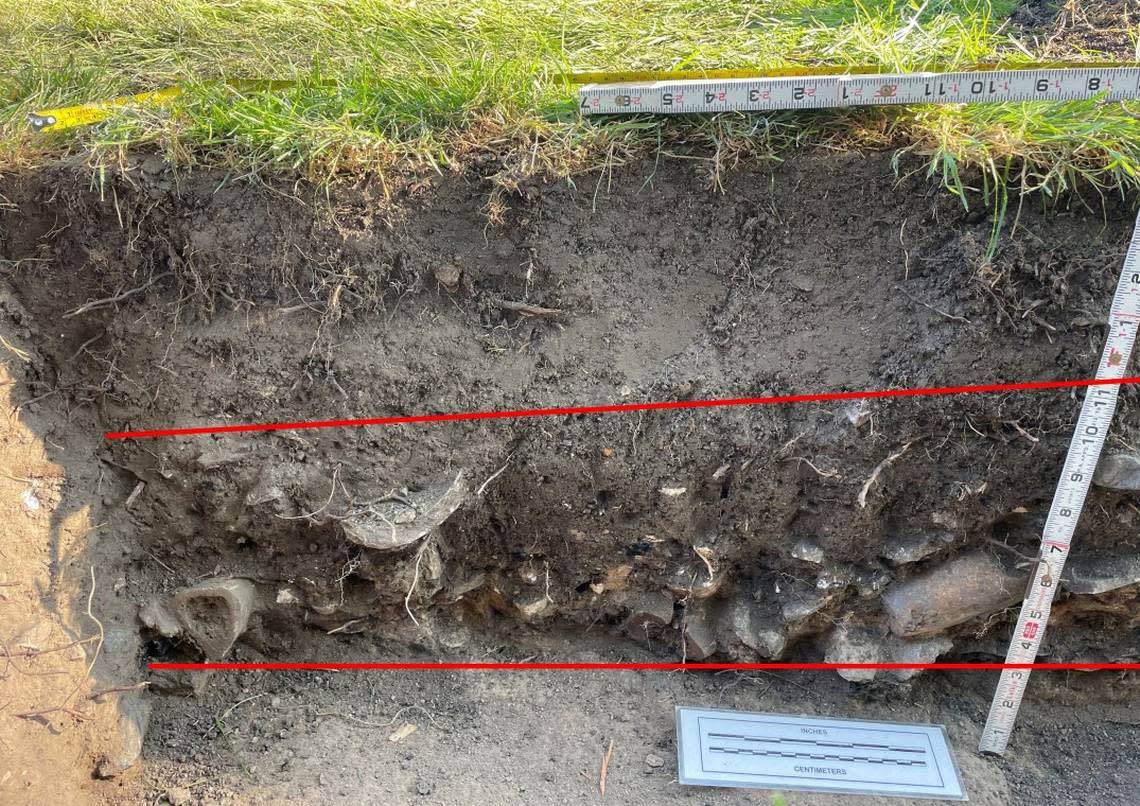 This photo shows the cross-section of soil where historical artifacts were found on the grounds of the Assay Office building in Boise. The red lines highlight the area where the artifacts were deposited.