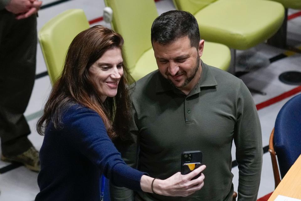 A woman takes a selfie with Ukrainian President Volodymyr Zelenskyy before he speaks at the SDG Summit at United Nations headquarters on Sept. 19, 2023.