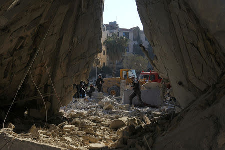 Civil defense members work at a site hit by airstrikes in the rebel-held city of Idlib, Syria February 7, 2017. REUTERS/Ammar Abdullah