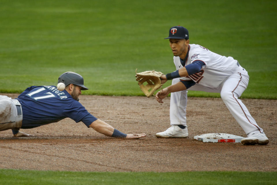 Minnesota Twins' Andrelton Simmons catches Seattle Mariners' Mitch Haniger off second base in the fifth inning of a baseball game Thursday, April 8, 2021, in Minneapolis. The Twins won 10-2. (AP Photo/Bruce Kluckhohn)