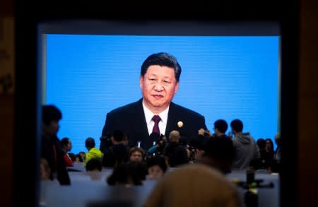 China's President Xi Jinping is seen on a big screen in the media center as he speaks at the opening ceremony of the first China International Import Expo (CIIE) in Shanghai on November 5, 2018.  Johannes Eisele/Pool via REUTERS