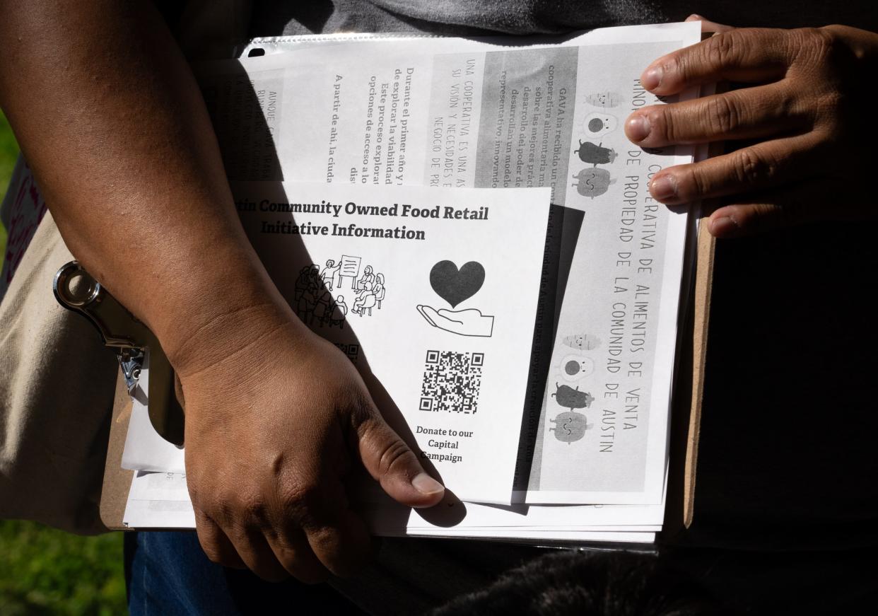 Go Austin/Vamos Austin Food Justice Organizer Erica Reyes carries a clipboard with flyers and information in English and Spanish while door knocking in Del Valle to gauge interest and gather opinions on bringing a city-sponsored food co-op to the low-income neighborhood that lacks a nearby grocery store, Saturday, Feb. 24, 2024.