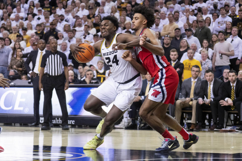 Missouri's Kobe Brown, left, dribbles around Mississippi's Jaemyn Brakefield, right, during the second half of an NCAA college basketball game Saturday, March 4, 2023, in Columbia, Mo. Missouri won 82-77. (AP Photo/L.G. Patterson)