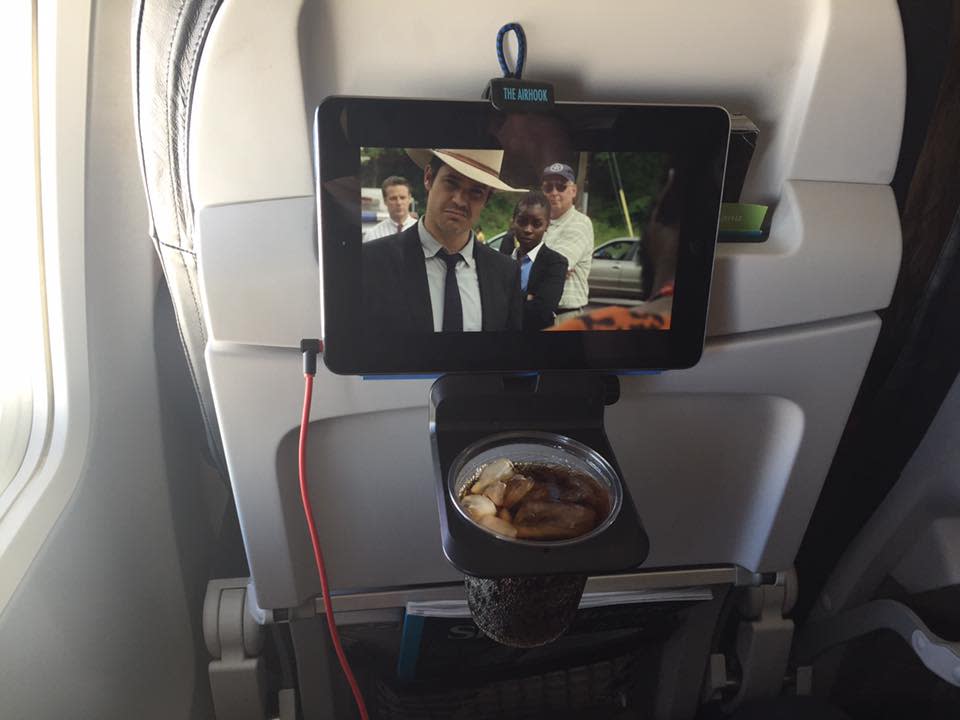 <p>(Cost: $28.95) We've all been there: You download a movie on your smartphone to watch on the plane, but then you have to awkwardly hold your device to watch the entire film. It's uncomfortable. Now you can use the <a rel="nofollow noopener" href="http://www.theairhook.com/" target="_blank" data-ylk="slk:Airhook;elm:context_link;itc:0;sec:content-canvas" class="link ">Airhook</a>, a mount that connects to the seat back of most planes so you can use your device hands-free. In addition to holding your iPad or iPhone, the Airhook also has a drink holder, so you can use your tray table for more important things…like airplane pretzels. </p>