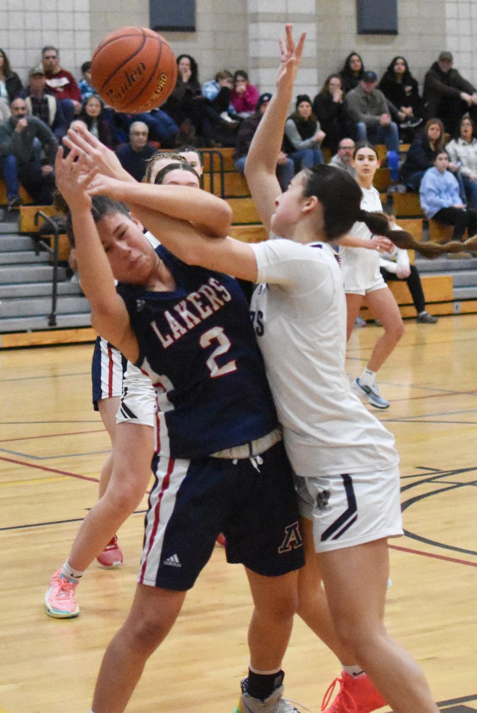 Apponequet's Cynthia Morales and Somerset Berkley's Karlie Cosme collide under the basket during Tuesday night's South Coast Conference game at Somerset Berkley Regional High School.