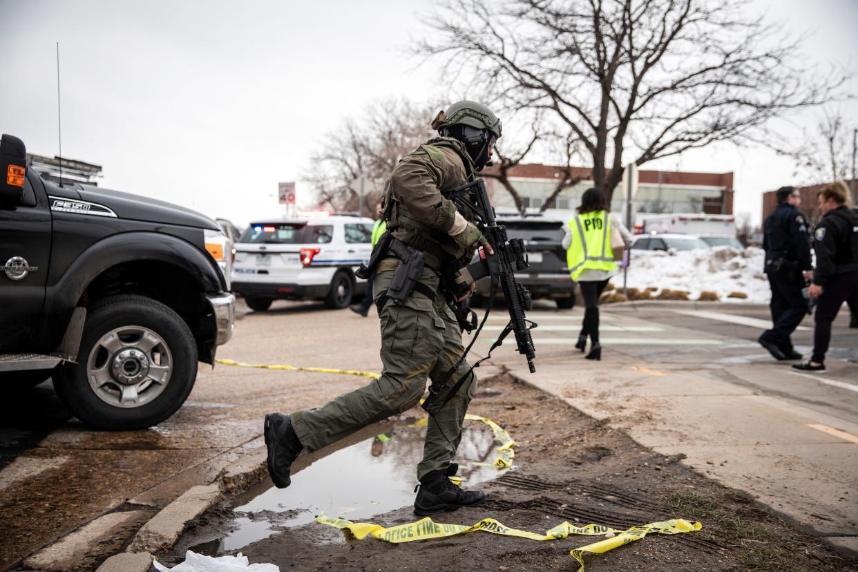 A SWAT team member runs toward a King Soopers grocery store where a gunman opened fire on March 22, 2021 in Boulder, Colorado.