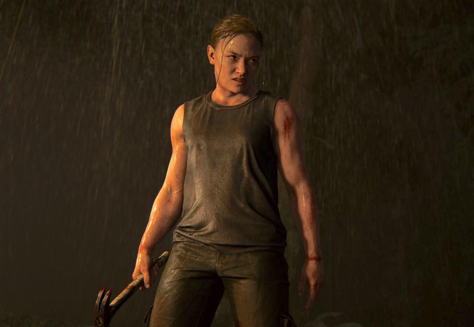 abby stands in the rain looking angry and holding a hammer in the last of us part ii