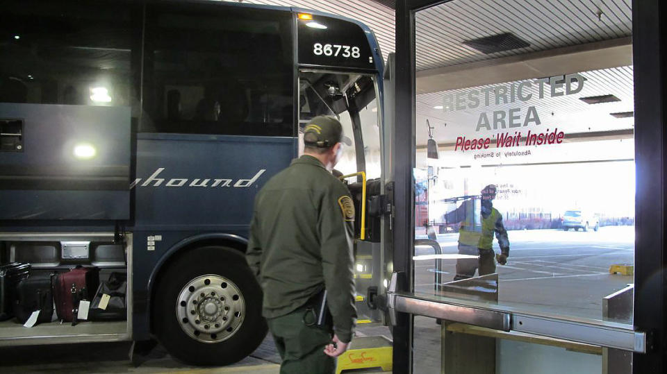 In this Thursday, Feb. 13, 2020 photo, agents for Customs and Border Protection board a Greyhound bus headed for Portland, Ore., at the Spokane Intermodal Center, a terminal for buses and Amtrak in Spokane, Wash. A Customs and Border Protection memo obtained by The Associated Press confirms that bus companies such as Greyhound do not have to allow Border Patrol agents on board to conduct routine checks for illegal immigrants, contrary to Greyhound's long insistence that it has no choice but to let the agents on board. (AP Photo/Nicholas K. Geranios)