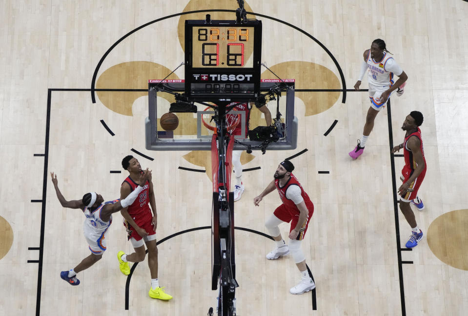 Oklahoma City Thunder guard Shai Gilgeous-Alexander goes after a rebound against New Orleans Pelicans guard Trey Murphy III (25) in the second half of Game 3 of an NBA basketball first-round playoff series in New Orleans, Saturday, April 27, 2024. The Thunder won 106-85. (AP Photo/Gerald Herbert)