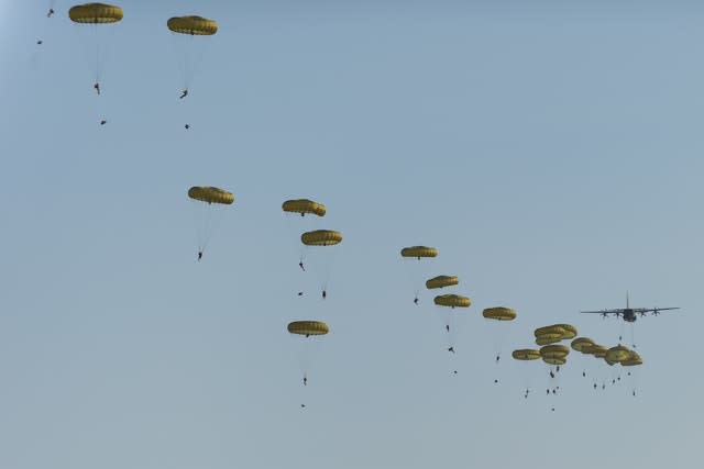 Troops exiting a Hercules C130 aircraft to parachute into Ukraine