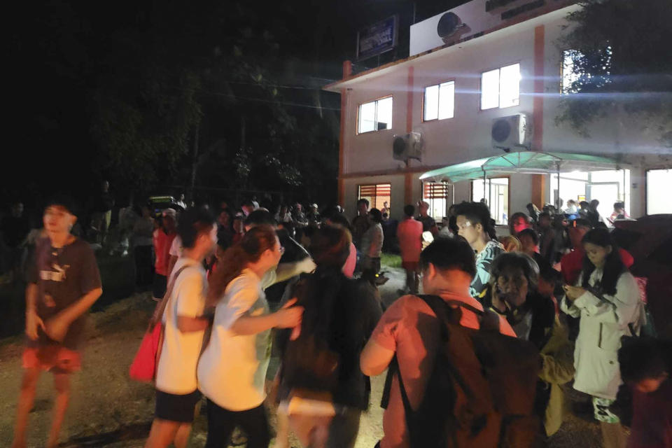 In this photo provided by the Local Government Unit of Hinatuan, villagers stay outdoors after an earthquake at Hinatuan town, Surigao del Sur province, southern Philippines, late Saturday, Dec. 2, 2023. A powerful earthquake with a preliminary magnitude of 7.6 struck Saturday off the southern Philippine coast, prompting many villagers to flee their homes in panic around midnight after Philippine authorities issued a tsunami warning. (LGU Hinatuan via AP)