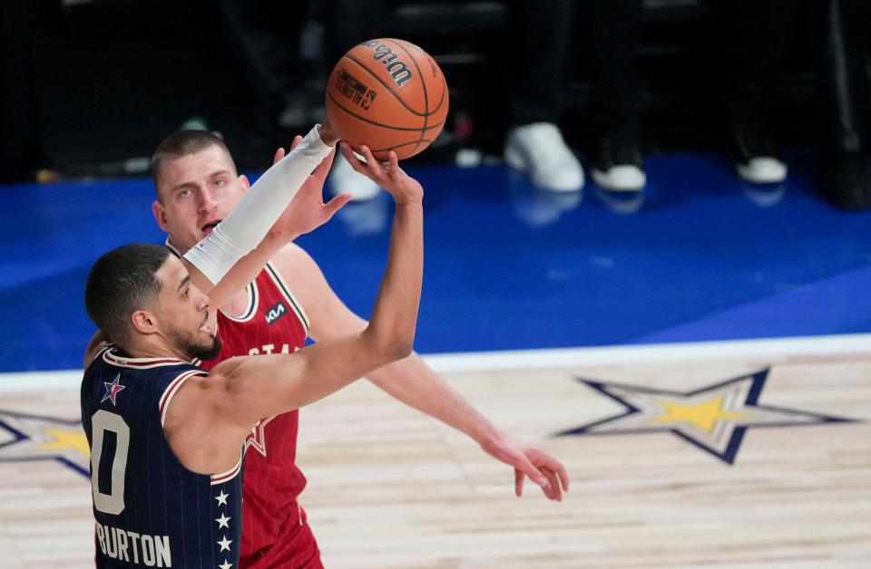 Eastern Conference guard Tyrese Haliburton (0) of the Indiana Pacers shoots a deep 3-point basket while being guarded by Western Conference center Nikola Jokic (15) of the Denver Nuggets on Sunday, Feb. 18, 2024, during the 73rd NBA All-Star game at Gainbridge Fieldhouse in downtown Indianapolis.