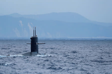 The Hai Lung SS-793 diesel-electric submarine emerges from underwater during a during a drill near Yilan naval base, Taiwan April 13, 2018. REUTERS/Tyrone Siu