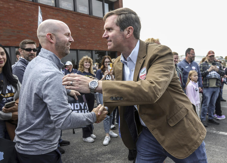 Kentucky Governor and Democratic candidate for re-election Andy Beshear, right, greets Owensboro resident Clay Ford while making a campaign stop at the Democratic Party of Daviess County Headquarters, Saturday, Nov. 4, 2023, in Owensboro, Ky. (Greg Eans/The Messenger-Inquirer via AP)