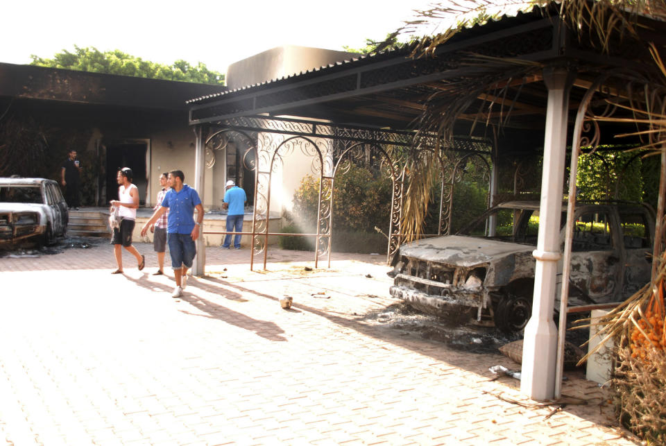 Libyans walk on the grounds of the gutted U.S. consulate in Benghazi, Libya, after an attack that killed four Americans, including Ambassador Chris Stevens, Wednesday, Sept. 12, 2012. (AP Photo/Ibrahim Alaguri)