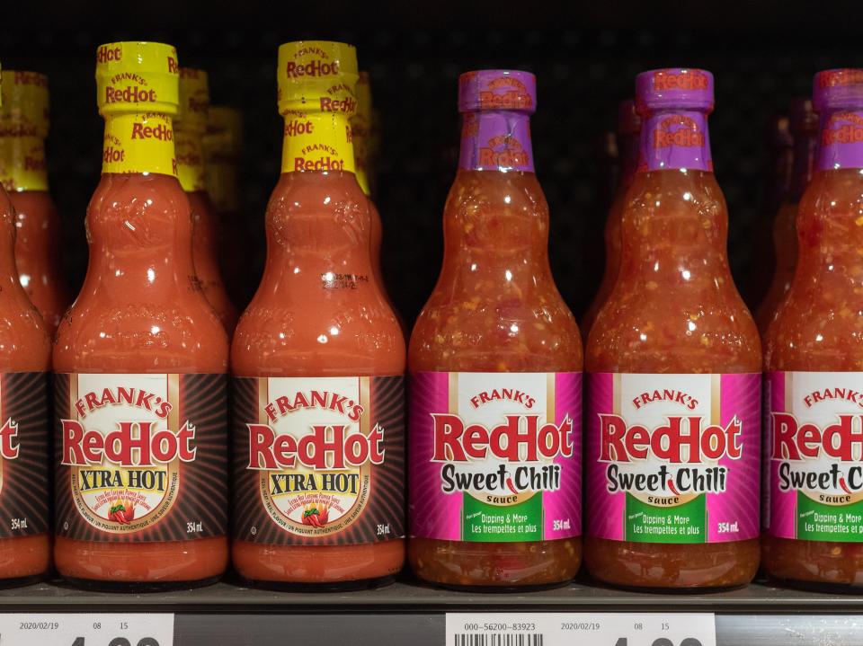 Bottles of Frank's RedHot Xtra Hot and Sweet Chili on a store shelf