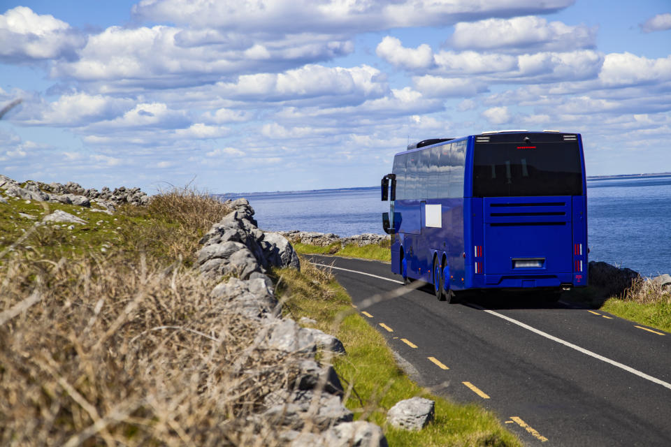 bus driving along a mountain side