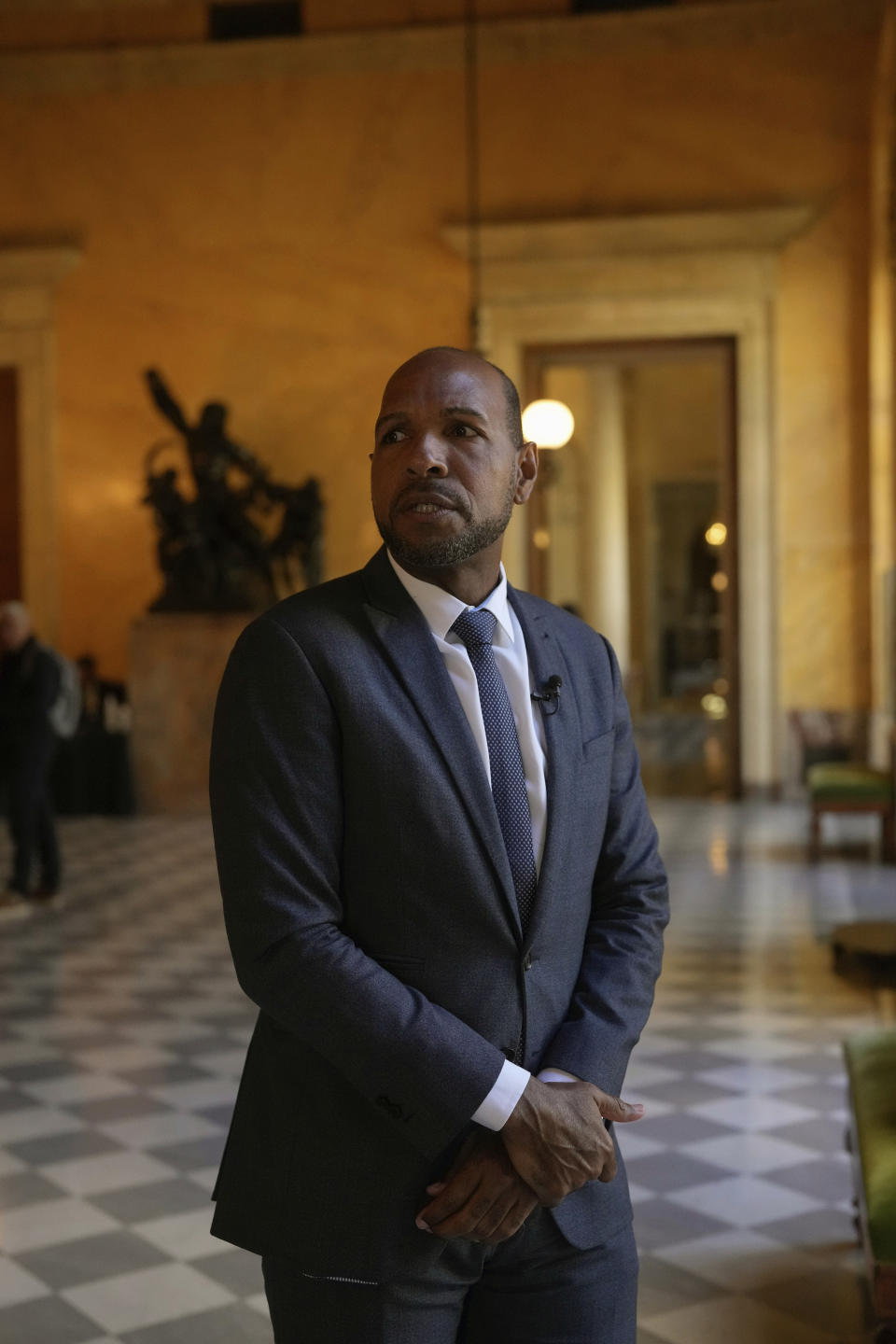 French Deputy of the National Assembly, Olivier Serva is photographed during an interview with The Associated Press, at the Nationial Assembly, in Paris, Wednesday, March 27, 2024. French lawmakers are debating a bill Thursday that would ban discrimination over the texture, length, color or style of someone's hair. (AP Photo/Thibault Camus)