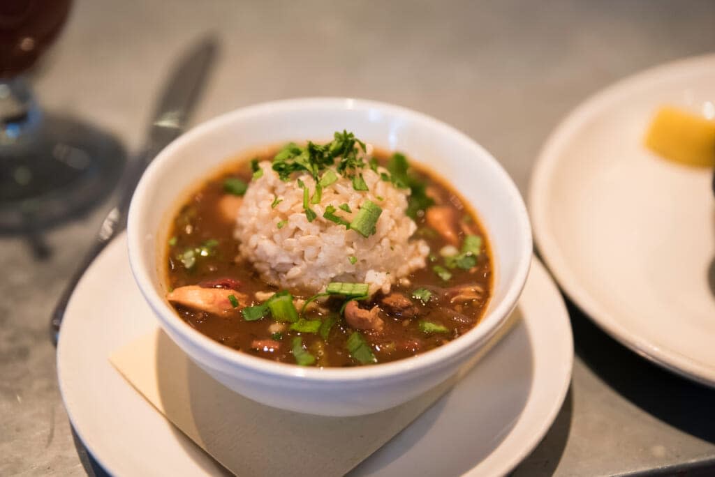 If your gumbo has a cute cone of rice in it covered in uncooked scallions, you are in a restaurant. Back away from the table. At Carla’s house, the bowl is chipped, and a server has not counted out exactly three shrimp and four sausage medallions. Find Carla’s. (Adobe Stock Image)