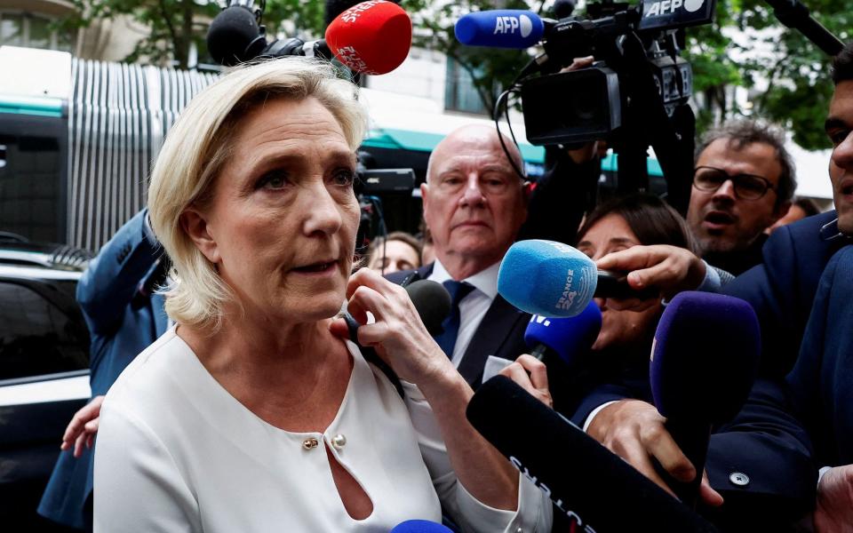 Marine Le Pen arrives at the RN party headquarters in Paris today