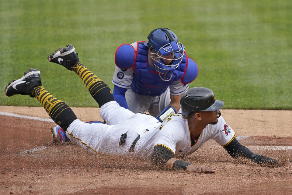 Los Angeles Dodgers catcher Austin Barnes, top, tags out Pittsburgh Pirates' Erik Gonzalez who was attempting to score on a fly out to right field by Ka'ai Tom during the second inning of a baseball game in Pittsburgh, Thursday, June 10, 2021. (AP Photo/Gene J. Puskar)