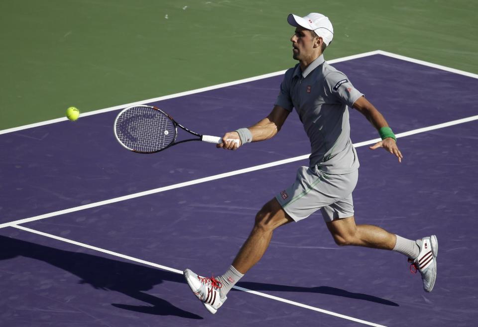 Novak Djokovic, of Serbia, returns the ball to Jeremy Chardy, of France, at the Sony Open tennis tournament, Friday, March 21, 2014, in Key Biscayne, Fla. (AP Photo/Lynne Sladky)