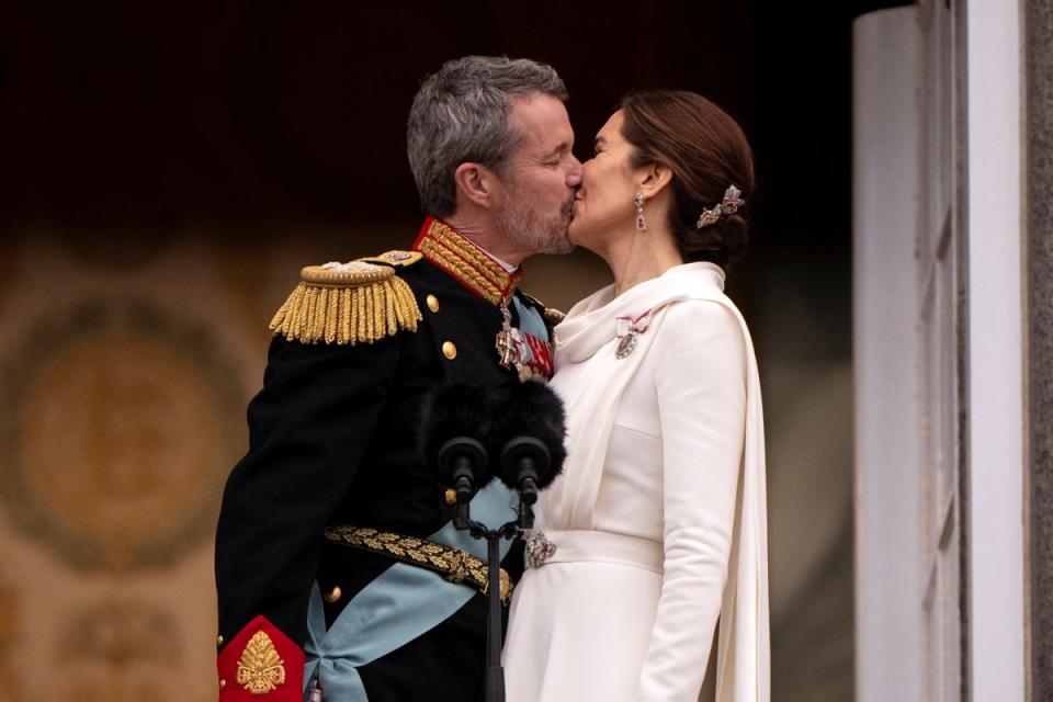 Denmark's newly proclaimed King Frederik and Queen Mary kiss on the balcony of Christiansborg Palace (Reuters)