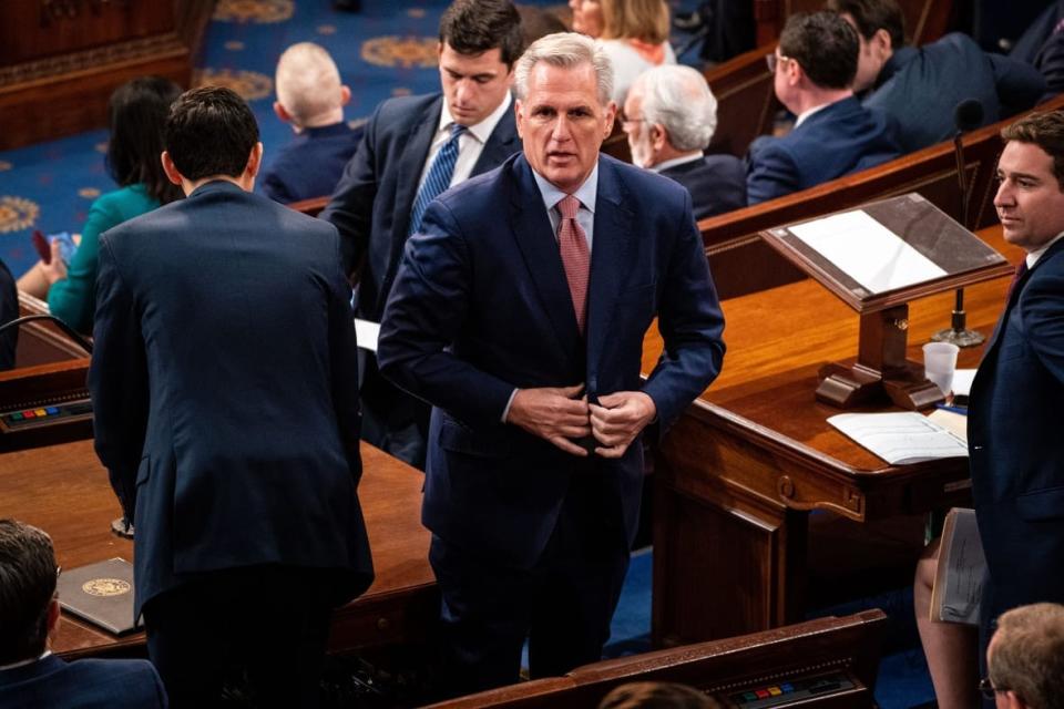 Rep. Kevin McCarthy (R-CA) buttons his jacket after standing up in the House Chamber of the U.S. Capitol Building on Tuesday, Jan. 3, 2023 in Washington, DC. Today members of the 118th Congress will be sworn in and the House of Representatives will hold votes on a new Speaker of the House. (Kent Nishimura / Los Angeles Times via Getty Images)