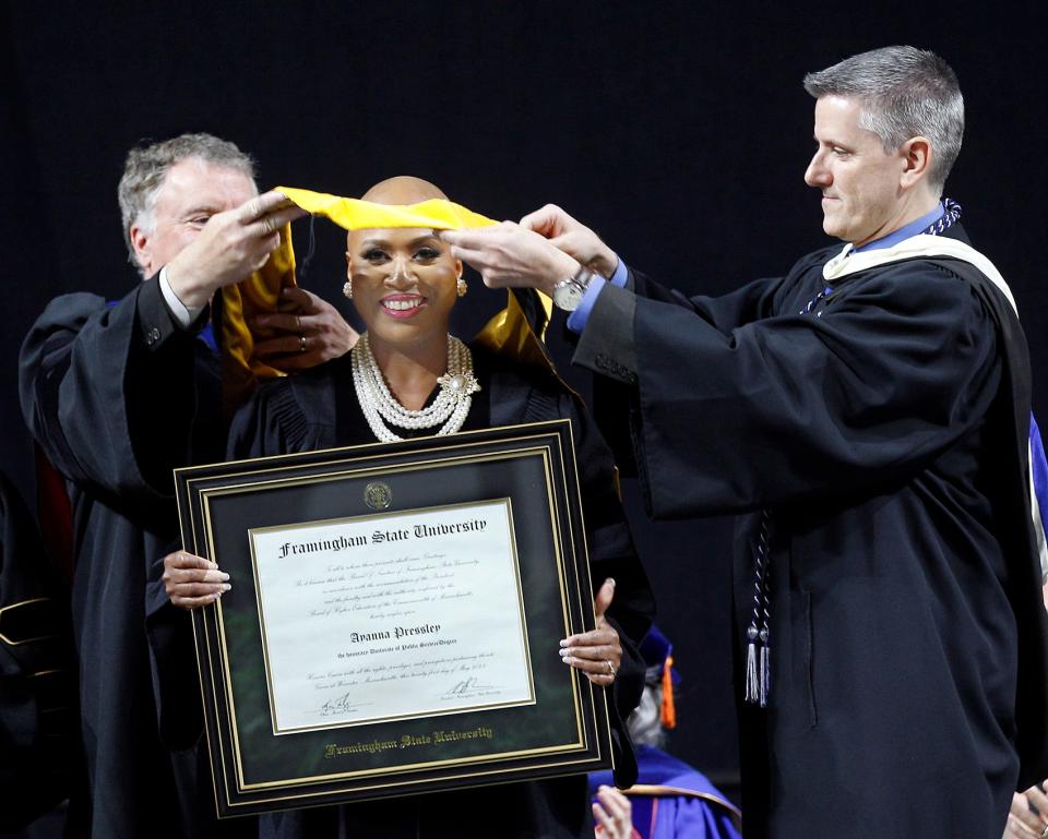 U.S. Congresswoman Ayanna Pressley, D-Mass., is presented with an honorary degree by Executive Vice President of Finance and Information Technology Dale Hamel, left, and Executive Director of Student Records and Registration Mark Powers during commencement exercises for Framingham State University at the DCU in Worcester, May 21, 2023.