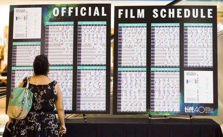 A woman looks at a film schedule before the opening night at the 40th Toronto International Film Festival in Toronto, Canada, September 10, 2015. TIFF runs from September 10-20. REUTERS/Mark Blinch