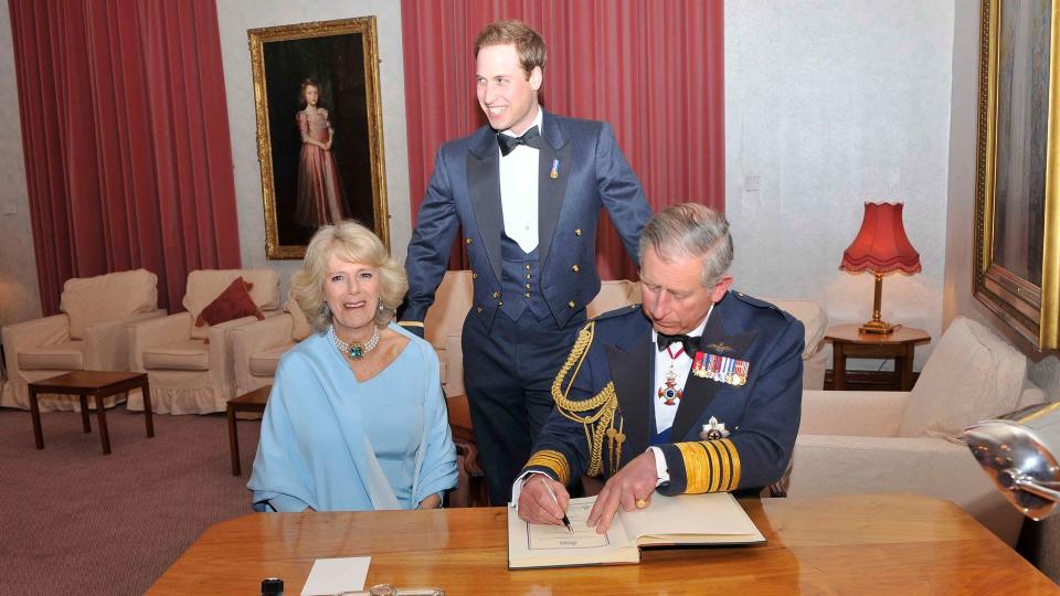 King Charles signs the visitors book at RAF Cranwell