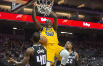 Golden State Warriors forward Draymond Green (23) dunks the ball against the Sacramento Kings during the first quarter of an NBA basketball game in Sacramento, Calif., Sunday, Oct. 24, 2021. (AP Photo/Randall Benton)